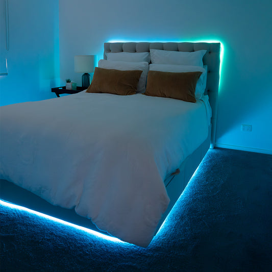 Bed adorned with vibrant light blue and light green Smart LED strip